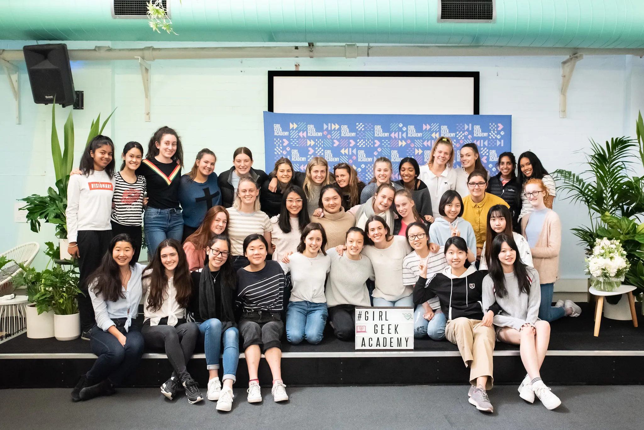 A group photo in front of a Girl Geek Academy backdrop