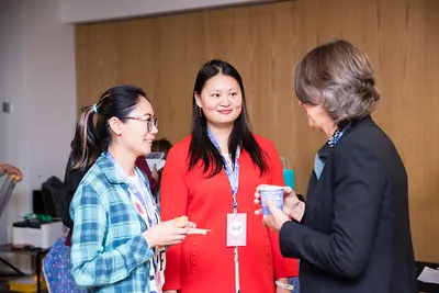 Three women chatting at an event