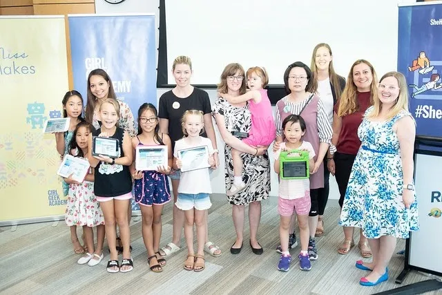 Girls and their mums holding certificates