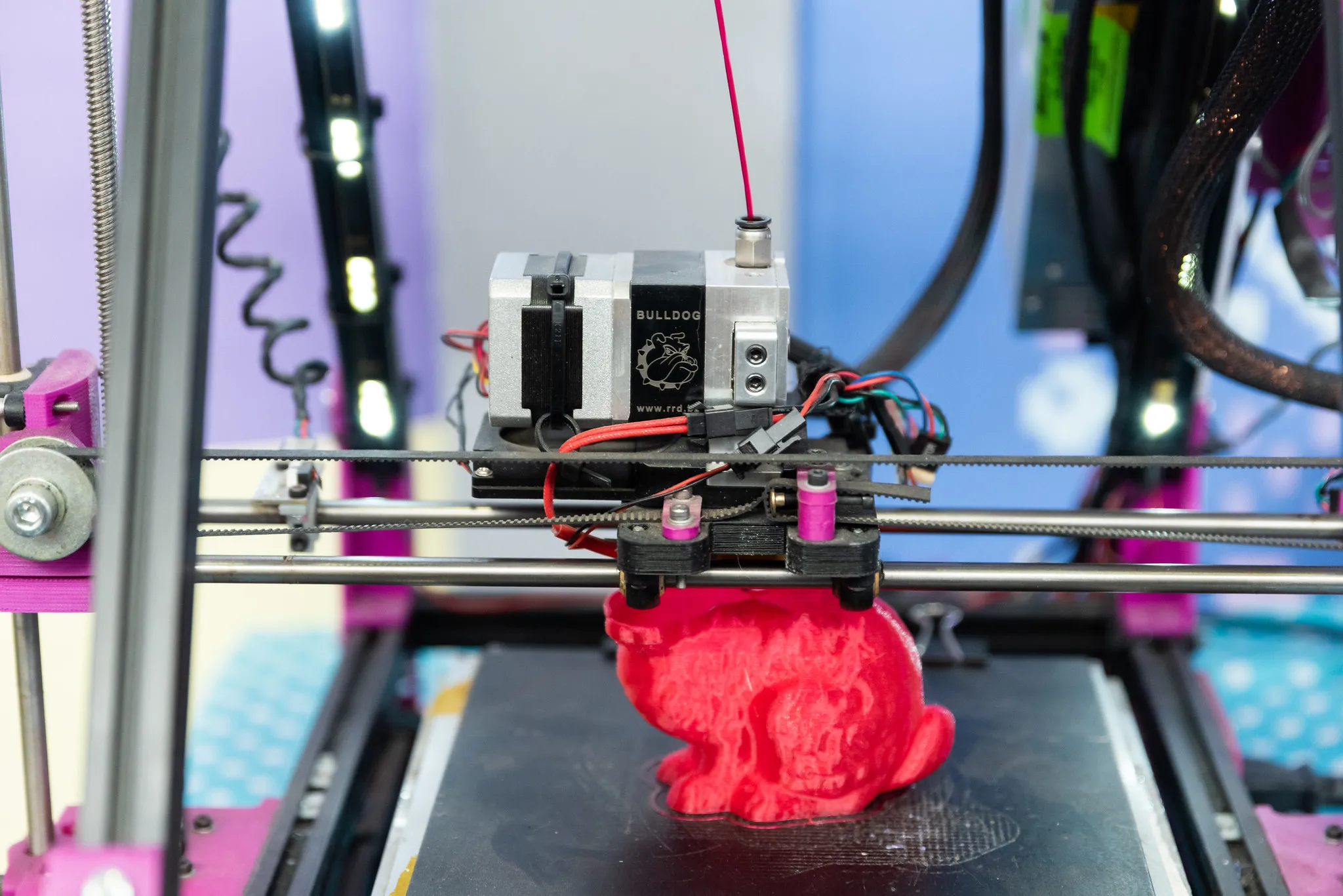 A 3D printer printing a red model