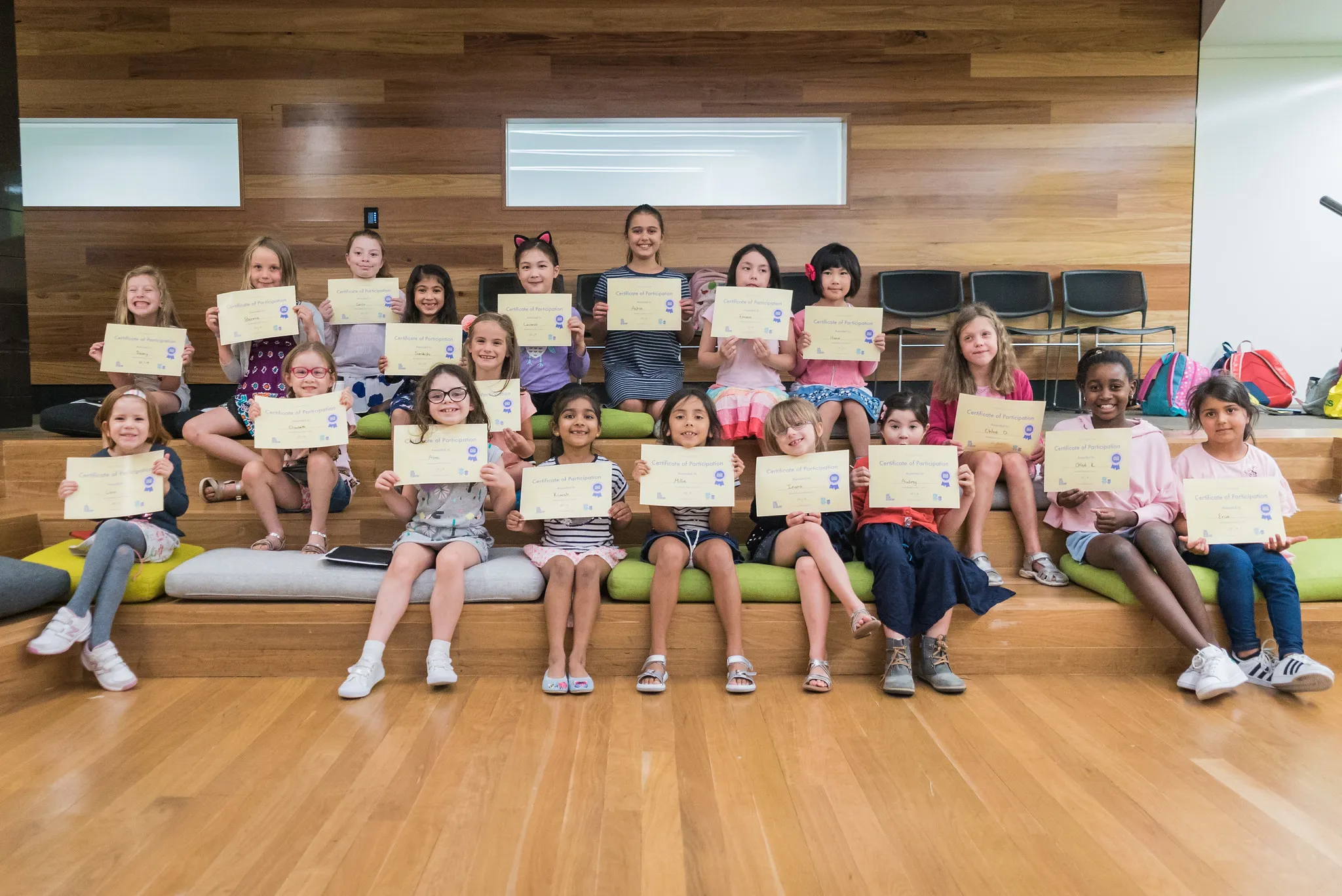 Girls holding up their certificates