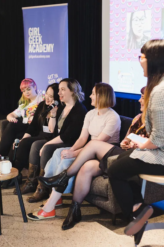 A panel of speakers on stage