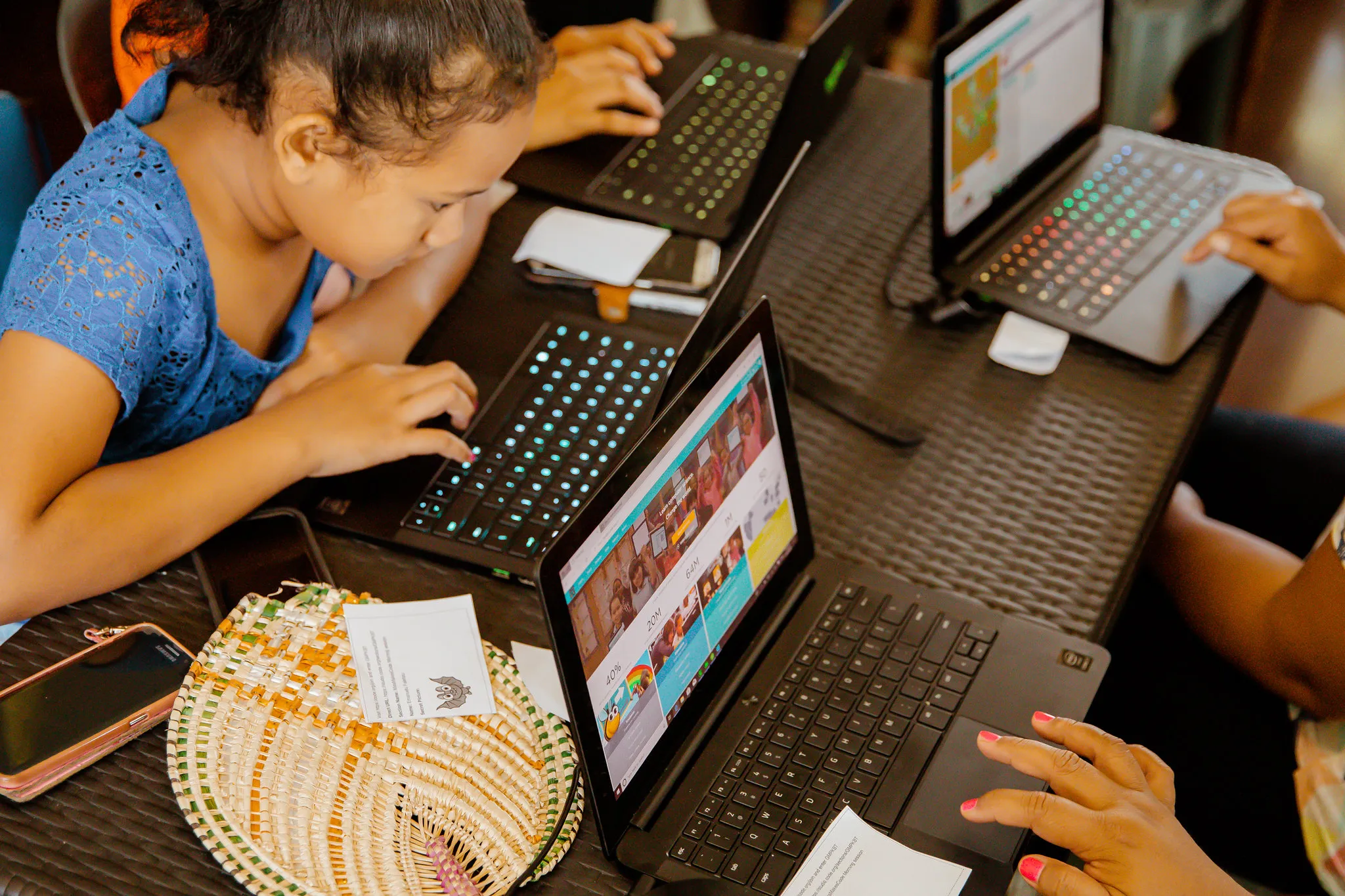 A girl coding on a tablet with a keyboard
