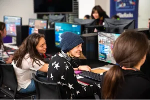 Girls gaming together at computers