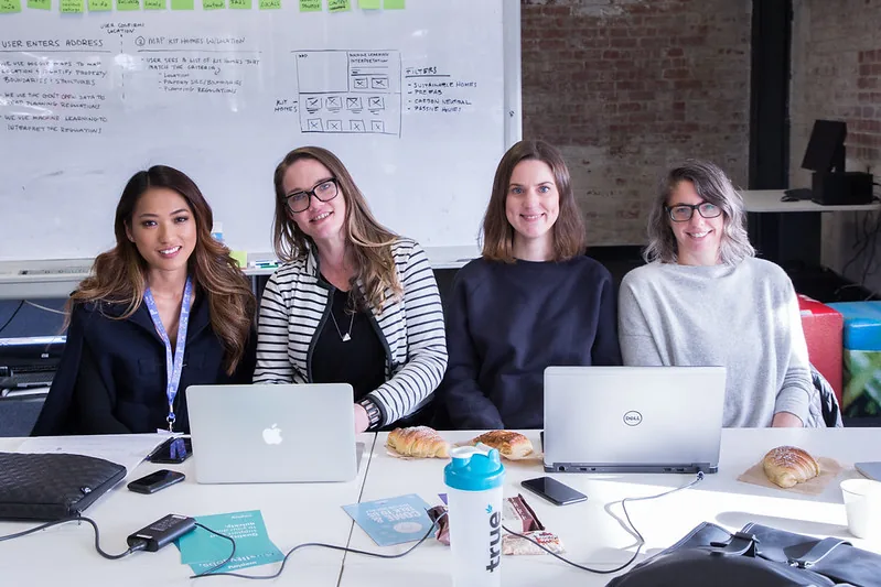 Four women at a table with laptops at #SheHacks 2017