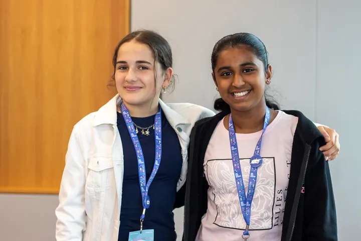 Two students with their arms around each other